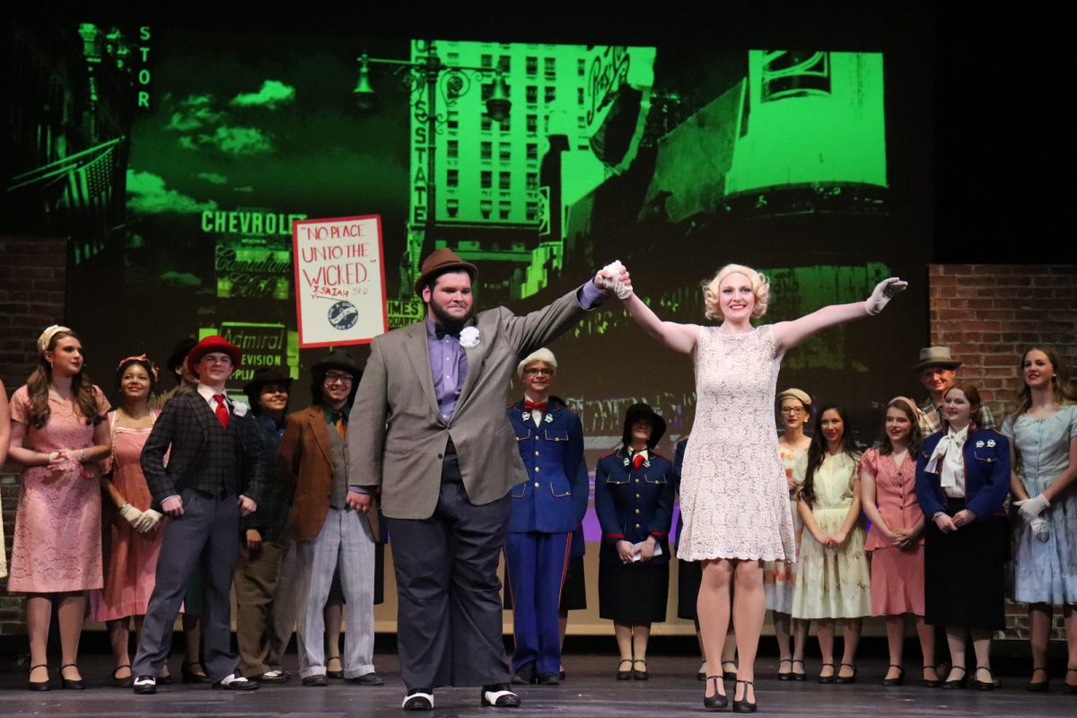 Liam Sheppeard-Housley (right) takes a bow as Nathan Detroit during Guys & Dolls. The show ran from April 23-25, 2026, in the Muscatine High School auditorium.