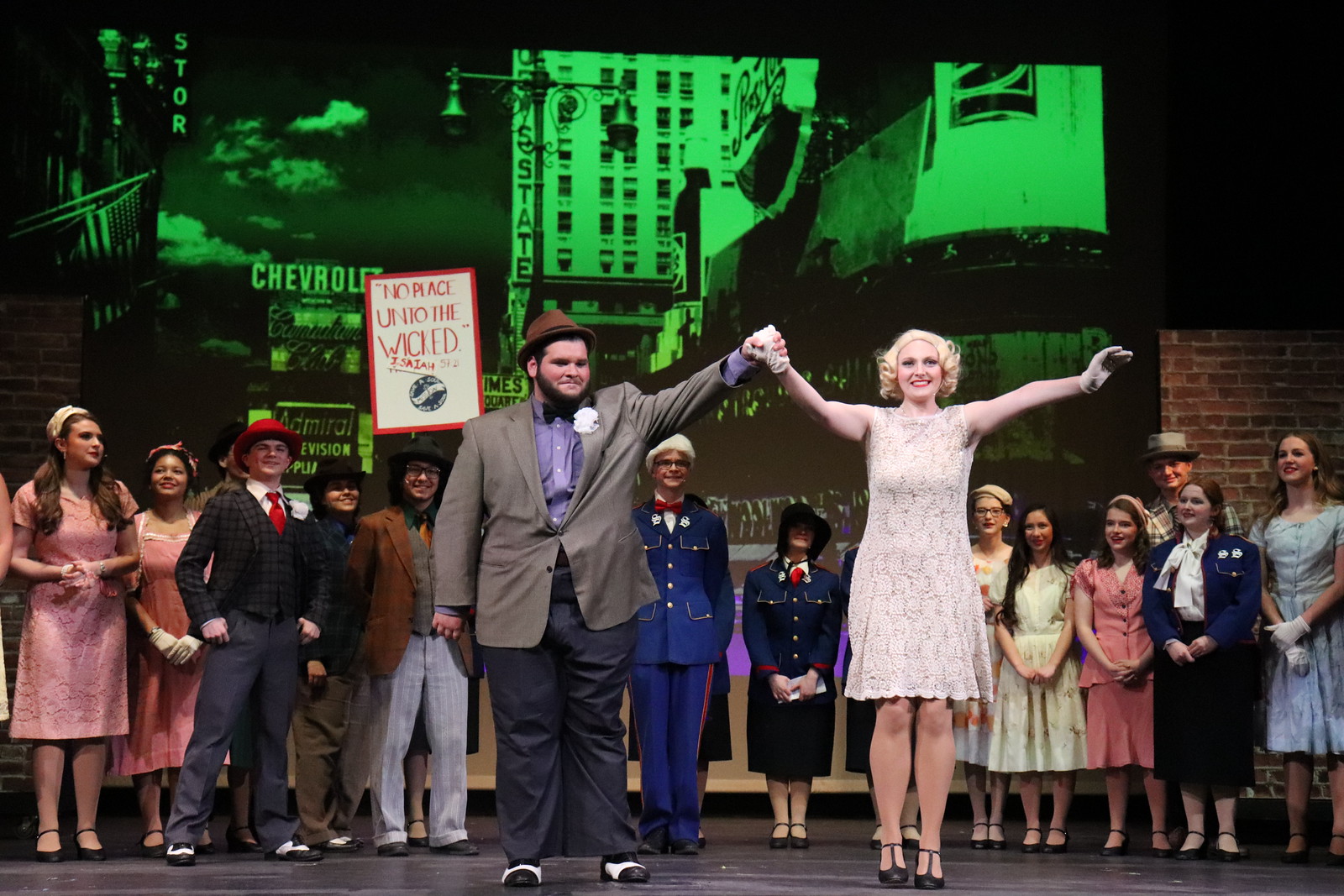 Liam Sheppeard-Housley (right) takes a bow as Nathan Detroit during Guys & Dolls. The show ran from April 23-25, 2026, in the Muscatine High School auditorium.